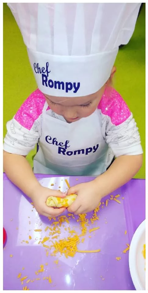 download-9 A little red head boy enjoying Romp n' Roll's cooking class.